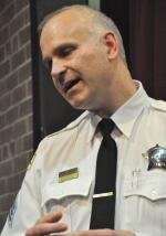 Sergeant Adam Henkels talks with people in Pritzker School HenkelsTlks